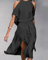 Madonna - Elegantes Kleid mit modischen Schulterausschnitten. in Schwarz