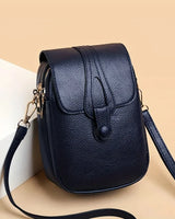 Kompakte Damen-Umhängetasche aus Leder mit minimalistischem Design und verstellbarem Riemen. in Blau