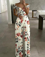 Damen Jumpsuit mit Off-Shoulder-Ausschnitt und Wickeloberteil mit weitem Bein in Weiß mit Blumendruck