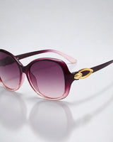 Damen-Sonnenbrille mit Schmetterlingsform und Metallic-Akzenten in Magenta