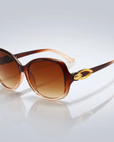 Damen-Sonnenbrille mit Schmetterlingsform und Metallic-Akzenten in Bernstein