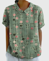 Kurzärmelige Damenbluse mit Blumenmuster und Bubikragen in Salbeigrün