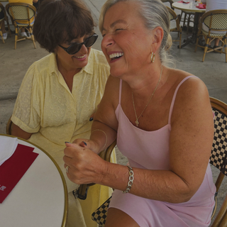 Zwei Kundinnen in Sommerkleidern im Cafe